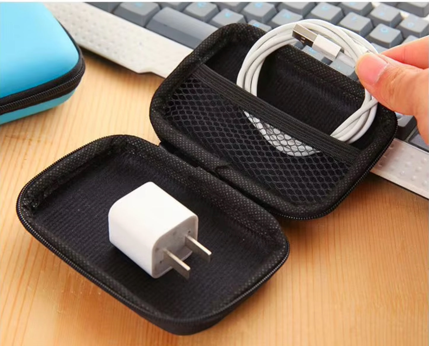 GLOVOYAGE™ AirCase Mini Tech Organizer holding a white USB-C cable and wall charger on a desk next to a keyboard.