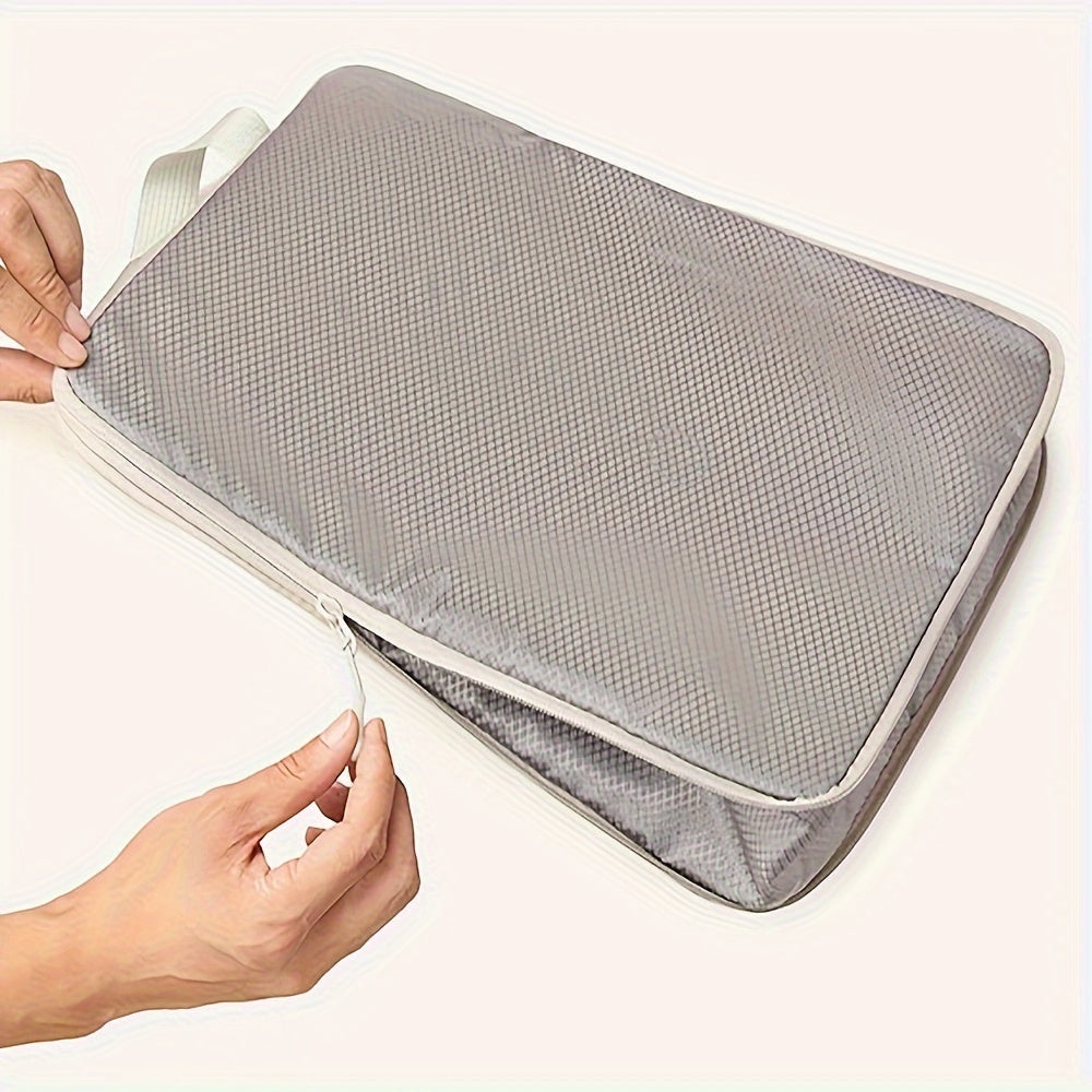 GLOVOYAGE™ grey compression packing cube being zipped shut by hands to demonstrate space-saving travel organization.