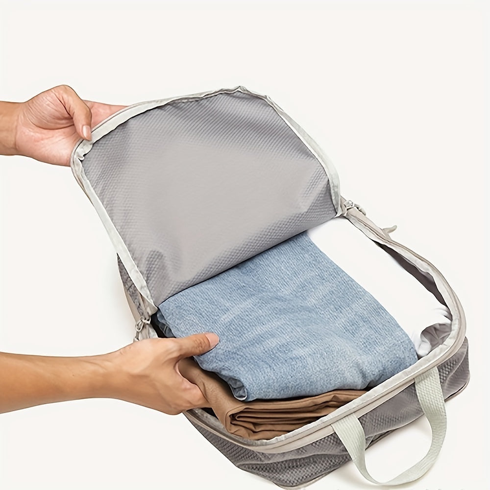Hands packing folded clothes into a grey GLOVOYAGE™ compression packing cube for organized travel storage.