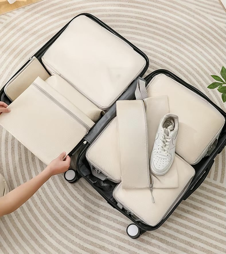 GLOVOYAGE™ 6-piece beige compression packing cube set organized inside an open black suitcase for travel storage