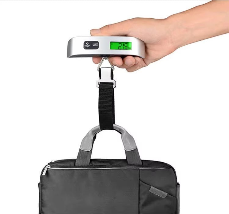 GLOVOYAGE™ portable digital luggage scale with LCD display weighing a black travel bag by a sturdy strap and hook
