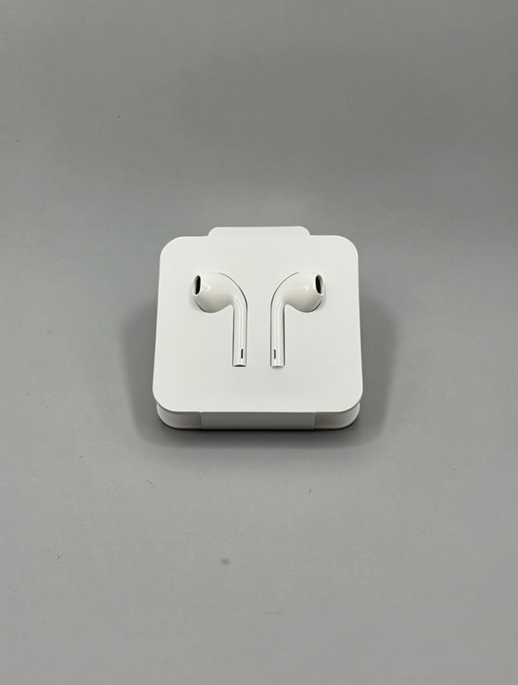 GLOVOYAGE™ white wired USB-C earbuds resting on a compact white travel case against a neutral grey background.
